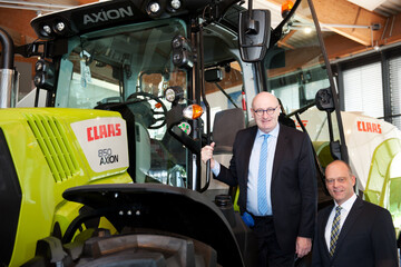 EU-Agrarkommissar Phil Hogan (l.) und Thomas Bck, Mitglied der Claas Konzernleitung, nutzten den Besuch fr ein Foto mit einem der modernen Claas Traktoren, die mit intelligenter Elektronik ausgestattet sind. 