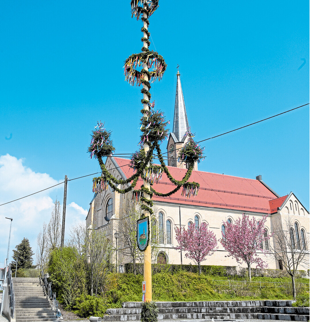 Jetzt sind die Dörfer wieder mit schönen Maibäumen geschmückt, wie dieser Baum mit kerzenleuchterartiger Girlande vor der neugotischen Kirche St. Ursula in Dieterskirch in der Gemeinde Uttenweiler im Landkreis Biberach.
