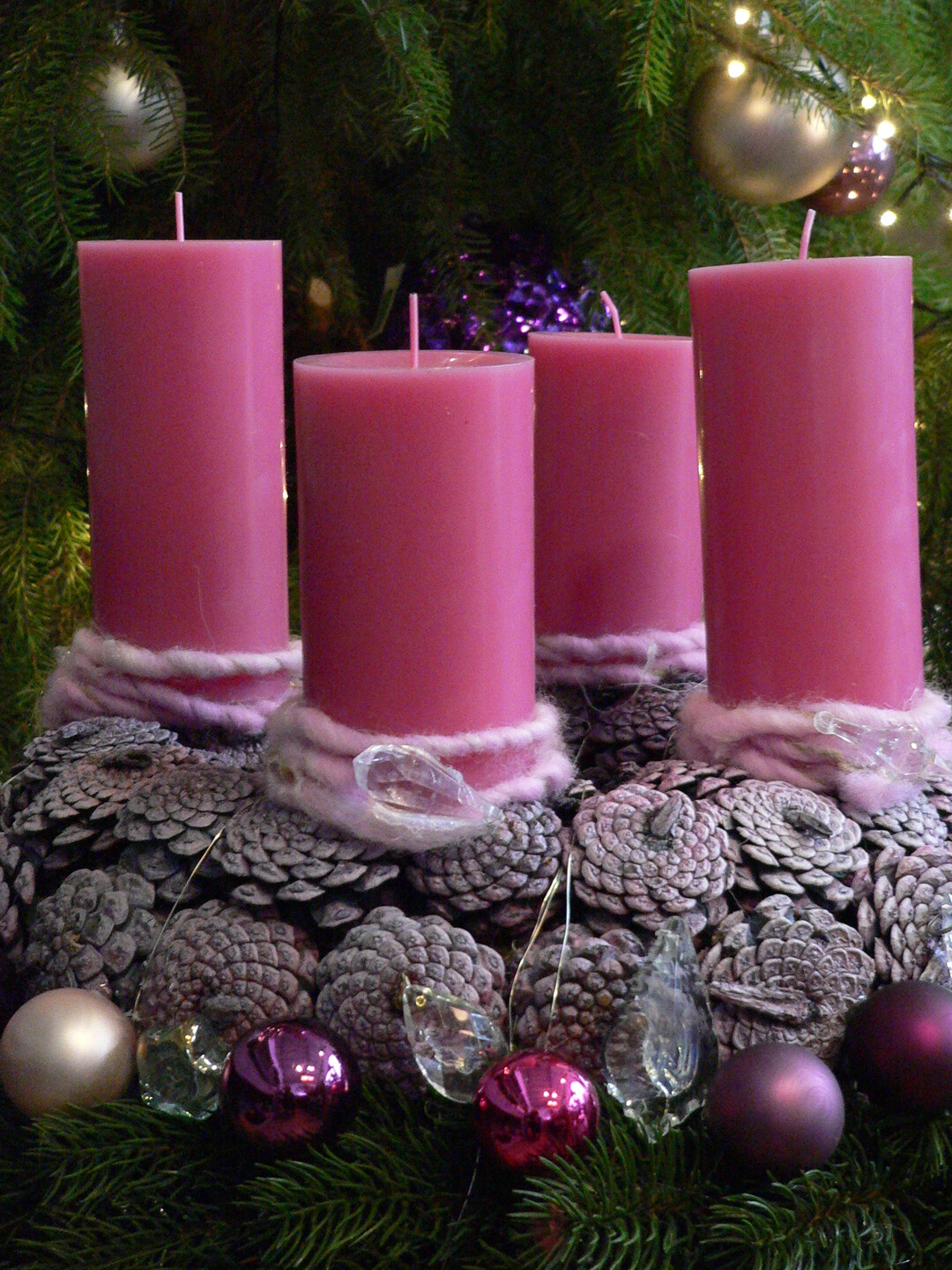 Der klassische Adventskranz aus Tannenzweigen und Zapfen wird durch die eleganten pinkfarbenen Kerzen in RAL-Qualität und wenigen, ausgesuchten Accessoires zu einem einzigartigen Ensemble.