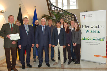 Der Parlamentarische Staatssekretär Peter Bleser (Mitte) übergibt den Zuwendungsbescheid für das neue Forschungsvorhaben, mit dem die Apfeltriebsucht eingedämmt werden soll.