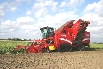 Mit einem Raupenfahrwerk vorne und Mehrfachreifen hinter bietet Grimme mehr Bodenschutz. Auch an diesem Roder sind Kpfer und Roder als Baugruppe unabhngig aufgehngt und passen sich mit Sttzrdern dem Boden gut an. Verbessert wird die Kpfqualitt durch Taster am Nachkpfer. Die angetriebenen Scheibenschare sind eine Besonderheit.